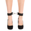 "Adjustable black ankle restraints with a metal connector clip, worn around ankles, paired with black high heels."