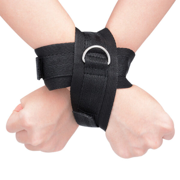 "Adjustable adhesive hand restraints made from durable black fabric with a metal ring, designed for secure and comfortable use during intimate moments."