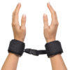 "Black adjustable wrist restraints with a secure buckle connection, offering a comfortable and reliable fit for various uses."