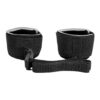 "Black adjustable wrist restraints with a secure buckle connection, offering a comfortable and reliable fit for various uses."