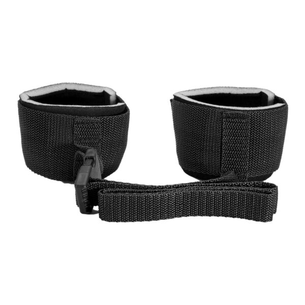 "Black adjustable wrist restraints with a secure buckle connection, offering a comfortable and reliable fit for various uses."