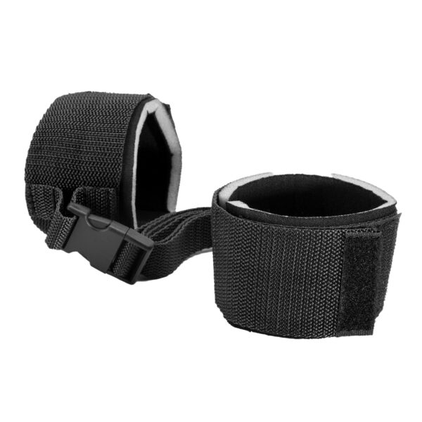 "Black adjustable wrist restraints with a secure buckle connection, offering a comfortable and reliable fit for various uses."